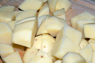 Close up of peeled peeling potatoes raw ready to cook
