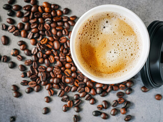 Coffee crema espresso in paper Coffee cup and bean on gray background, Top view of Espresso in  Takeaway paper coffee cup.
