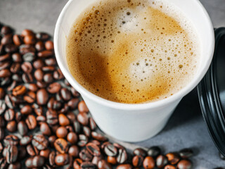 Coffee crema espresso in paper Coffee cup and bean on gray background, Top view of Espresso in  Takeaway paper coffee cup.