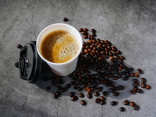 Coffee crema espresso in paper Coffee cup and bean on gray background, Top view of Espresso in  Takeaway paper coffee cup.