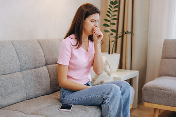 Sick Woman Coughing at Home Sitting on Sofa