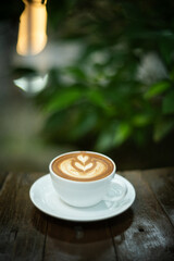 Background Coffee cup and beans on old kitchen table. Hot art Latte Coffee.
