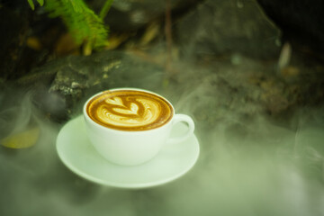 Background Coffee cup and beans on old kitchen table. Hot art Latte Coffee.
