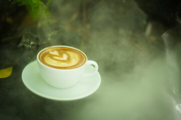 Background Coffee cup and beans on old kitchen table. Hot art Latte Coffee.

