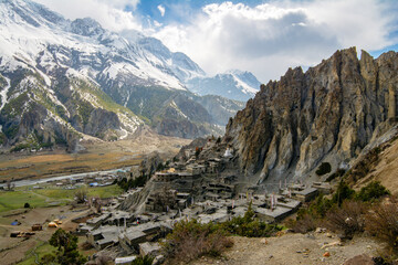 View of Buddhist Bhrakaa or Bhraka Monastery, Marsyangdi river, mountains and rocks in Himalayas, Annapurna Conservation Area, Nepal. Snow capped landscape. Annapurna Circuit Trek. Hiking, trekking