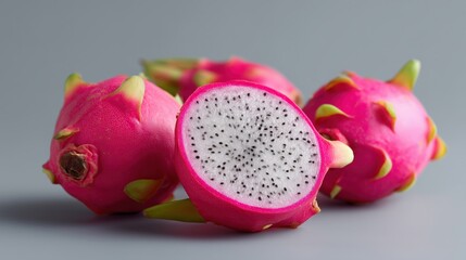 Fresh Dragonfruit Displayed on a Gray Surface With a Vibrant Pink Exterior and White, Speckled Interior Generative AI