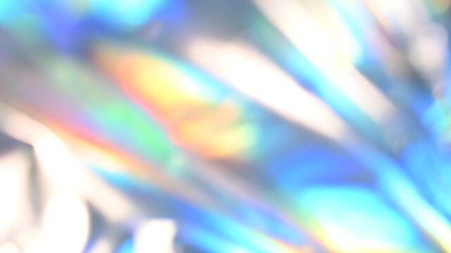 Shiny holographic foil with colorful reflections creates a and vibrant captivating rainbow background video 4k