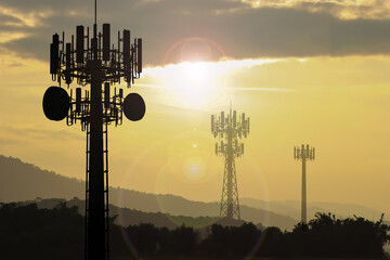 Silhouette communication cell tower sunset background