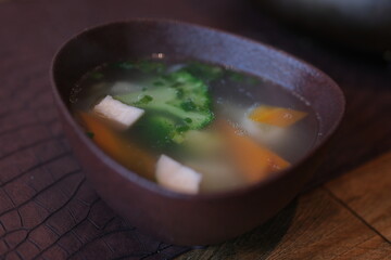 cooking tofu soup with onions and tomatoes in the kitchen with an electric stove. High quality 4k footage