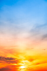 Sky,Beautiful sunset view, luxury soft gradient orange gold clouds and sunlight on the blue dramatic sky perfect for the background, morning, evening,Twilight, climate change,Vertical sunset photo