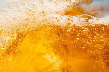 Close up bright orange Oil or beer splash texture and nature waves, Beautiful waves curve and little bubbles smooth for graphic design and background, Oil Bubbles, Soft beer bubbles, Selective focus