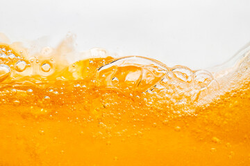 Close up bright orange Oil or beer splash texture and nature waves, Beautiful waves curve and little bubbles smooth for graphic design and background, Oil Bubbles, Soft beer bubbles, Selective focus