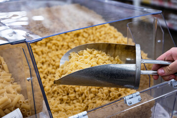 Pasta selection in a grocery store with a scoop for customers to choose their favorite types