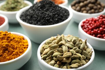 Different aromatic spices on grey table, closeup
