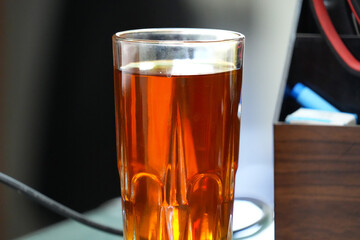 Delicious jasmine tea with blurred background. Tea served while working.