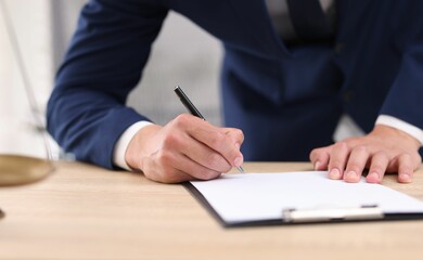 Judge working at wooden desk indoors, closeup