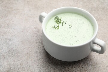 Tasty cucumber soup with dill on grey table, closeup. Space for text