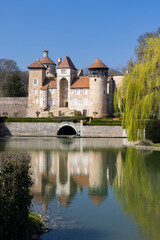 Chateau de Sercy reflecting in the moat in Saone et Loire, Bourgogne Franche Comte, France