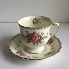 Fototapeta premium antique porcelain cup and saucer with floral pattern