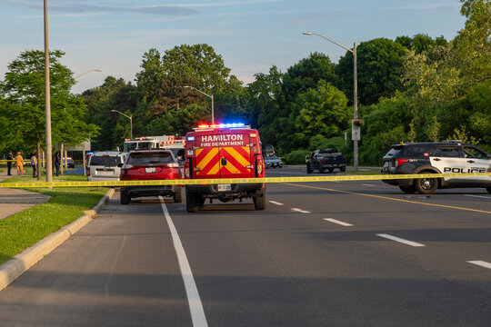 Police SUV, paramedics, ambulances, fire trucks present at multi vehicle crash accident scene at area closed off with yellow tape, Hamilton, Canada. Reckless, dangerous driving, dui concept.