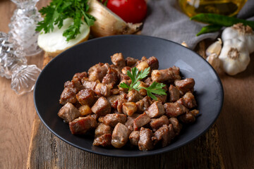 Muslims Traditional Sacrifice holiday food lamb, Turkish roasted meat in copper pot on table top. Turkish Kavurma. (Turkish name; Kurban kavurma)
