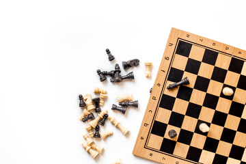 White and black chess pieces on chessboard during the game, top view