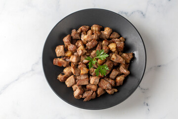 Muslims Traditional Sacrifice holiday food lamb, Turkish roasted meat in copper pot on table top. Turkish Kavurma. (Turkish name; Kurban kavurma)