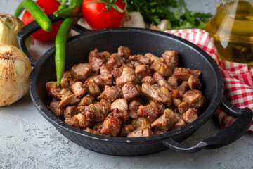 Muslims Traditional Sacrifice holiday food lamb, Turkish roasted meat in copper pot on table top. Turkish Kavurma. (Turkish name; Kurban kavurma)