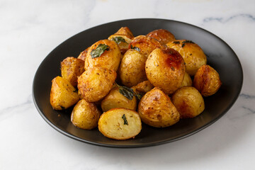 Roasted baked baby potatoes with garlic and herbs.