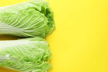 Fresh Chinese cabbages on yellow background, top view. Space for text