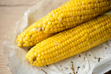Hot organic boiled corn with herbs for a vegan snack.