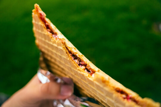 Close-up of a bitten oblea, a typical Colombian street sweet, for eating out concept. High quality photo