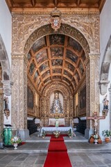 Historic Church Interior With Ornate Coffered Ceiling And Red Carpet Aisle In Angra Do Heroismo....