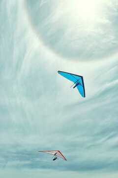 two gliders flying with a sun halo on a summer's day