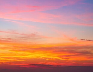 Obraz premium The sky is a vibrant orange, painted with hues of gold and crimson, as the sun sets on the horizon, casting a warm glow over the landscape.