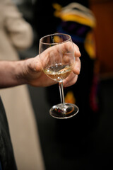 Sommelier holding glass of white wine during tasting