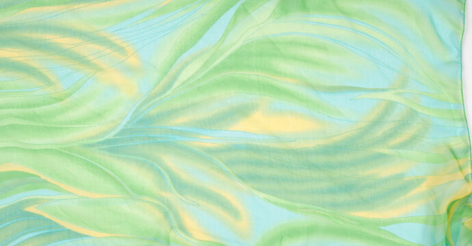 Seamless kaleidoscope. Fabric silk green-blue shades. Vibrant colors and scalloped shapes create a truly unique crepe de chine in yellow, blue and green geometric silk crepe de chine.