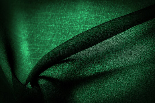 Background texture Dark green chiffon silk is a soft transparent fabric with a slight roughness (matte, creped) due to the use of twisted yarn.