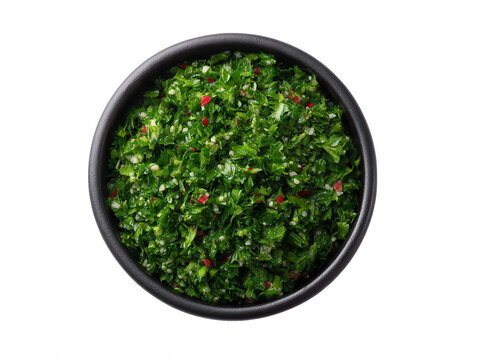 A vibrant bowl of freshly made tabbouleh salad, showcasing parsley, mint, tomatoes, and buur wheat, is presented against a clean white background for a healthy meal.