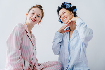 Teenage daughter joking around with mother during fun morning skincare