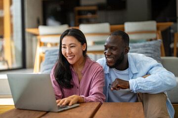 A happy, multi-national couple who are digital nomads and work from a different country every month