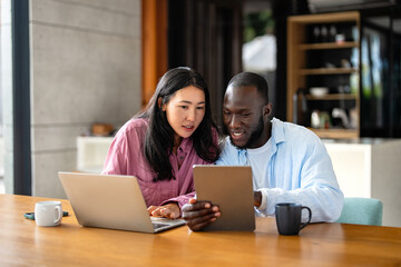 Man and woman working remotely using laptop. Male female freelancers working together. Digital nomad