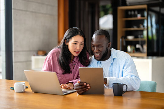 Man and woman working remotely using laptop. Male female freelancers working together. Digital nomad