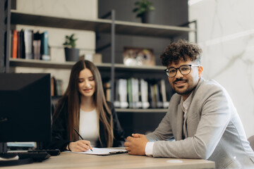Professionals Working Together in a Modern Office with Friendly Collaboration