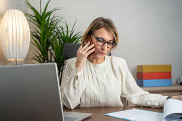 Software designer speaking to his client on the phone in an office