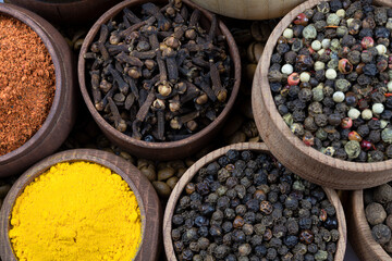 Assortment of spices in wooden bowls close-up. Top view.