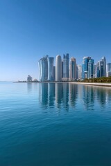 Fototapeta premium Cityscape vista with towering buildings reflected in blue water under a clear sky