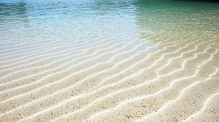 Natural beach sand with rhythmic wave formations and soft shadows adding dimension and tranquility