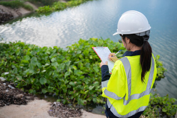 Environmental engineers work at the water storage plant, check the pH of the water, check the...