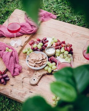 Outdoor picnic with snacks and wine on a wooden table